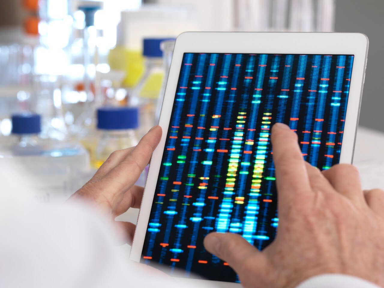 MODEL RELEASED. Scientist viewing results of a genetic test on a digital tablet.