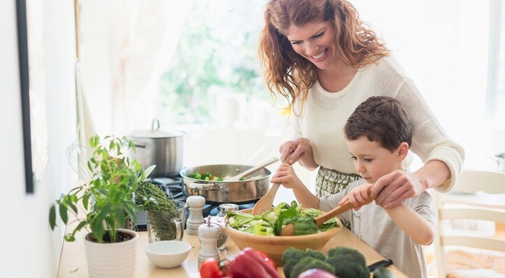 Mother and son preparing healthy meal full of foods with vitamin E