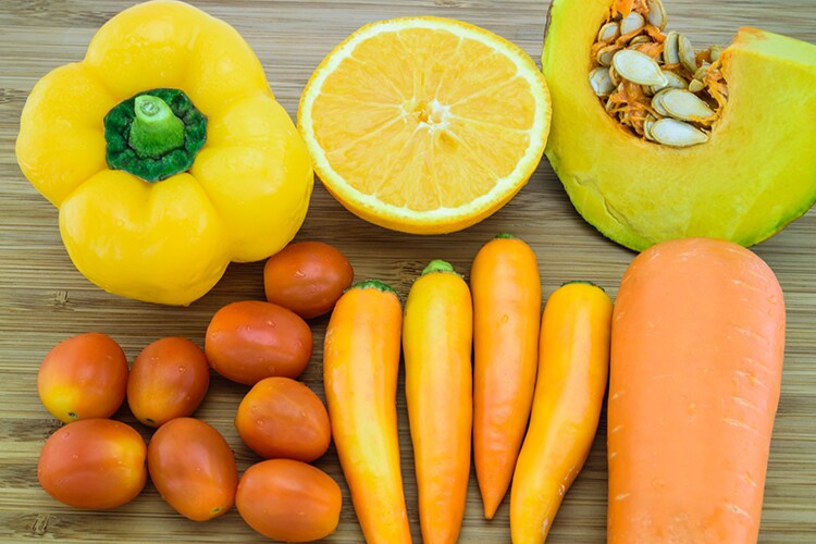 Variety of Orange color fruits and vegetables which are a good source of beta-carotene