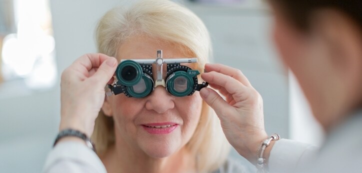 Female doctor examining senior patient vision